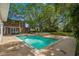 Inviting pool with tile accents in backyard, surrounded by well-maintained lawn and mature trees, perfect for relaxation at 4003 N Ocean Blvd., Myrtle Beach, SC 29577