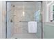 Shower featuring marble tile, glass door, and a towel bar for convenience at 4003 N Ocean Blvd., Myrtle Beach, SC 29577