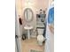 Comfortable bathroom with a pedestal sink, toilet, mirror, and an open storage shelf at 407 24Th Ave. N # 302, North Myrtle Beach, SC 29582