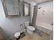 Bright bathroom featuring a toilet, shower and tub combination, decorative mirrors, and tile floors at 407 24Th Ave. N # 302, North Myrtle Beach, SC 29582