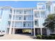 Condo building featuring pastel exterior, stacked balconies and covered parking at 407 24Th Ave. N # 302, North Myrtle Beach, SC 29582