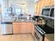 Open-concept kitchen with stainless steel appliances and an eat-in bar area at 407 24Th Ave. N # 302, North Myrtle Beach, SC 29582