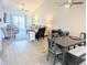 Open living area with seating, dining table, and hardwood floors at 407 24Th Ave. N # 302, North Myrtle Beach, SC 29582