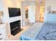 Relaxing main bedroom featuring a fireplace, flatscreen television, and en suite bathroom at 407 24Th Ave. N # 302, North Myrtle Beach, SC 29582