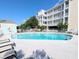 Outdoor pool with deck chairs, a clubhouse, and easy access to the beach at 407 24Th Ave. N # 302, North Myrtle Beach, SC 29582