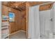 Simple bathroom featuring a shower stall and basic fixtures, with essential amenities and a window view at 414 32Nd Ave. N, North Myrtle Beach, SC 29582