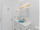 Well-lit bathroom featuring a light turquoise sink, white cabinetry and unique light fixture at 414 32Nd Ave. N, North Myrtle Beach, SC 29582