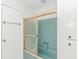 Bathroom featuring a shower tub combo with gold sliding glass door, and white cabinetry at 414 32Nd Ave. N, North Myrtle Beach, SC 29582