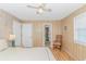 Bedroom with natural wood paneling, ceiling fan, and light colored wood laminate flooring at 414 32Nd Ave. N, North Myrtle Beach, SC 29582