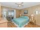 Bedroom featuring a slider to the porch, ceiling fan, natural wood paneling and wood laminate flooring at 414 32Nd Ave. N, North Myrtle Beach, SC 29582