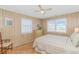 Bright bedroom with two windows, ceiling fan, chair, and light colored wood laminate flooring at 414 32Nd Ave. N, North Myrtle Beach, SC 29582