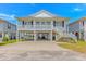 Classic beach house on stilts offering covered parking and a welcoming staircase at 414 32Nd Ave. N, North Myrtle Beach, SC 29582