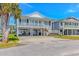 Charming raised beach house with white railings and ample ground-level parking at 414 32Nd Ave. N, North Myrtle Beach, SC 29582