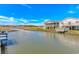 Waterfront home with a cozy porch overlooking the waterway and marsh, under a bright blue sky at 414 32Nd Ave. N, North Myrtle Beach, SC 29582