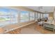 Open living room offering waterfront views through a wall of large windows, great natural lighting, and comfortable seating at 414 32Nd Ave. N, North Myrtle Beach, SC 29582