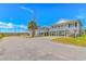 Bright neighborhood street showcasing raised beach homes, lush palms, and sunny skies at 414 32Nd Ave. N, North Myrtle Beach, SC 29582