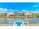Water view of three houses from the dock, with a bright blue sky and scattered white clouds at 414 32Nd Ave. N, North Myrtle Beach, SC 29582