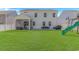 Expansive backyard features a screened-in porch, patio seating, and a play area at 456 Cattle Drive Circle, Myrtle Beach, SC 29588