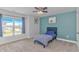Cozy bedroom with a large window overlooking the street and a view of the neighborhood at 456 Cattle Drive Circle, Myrtle Beach, SC 29588