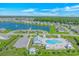 Aerial view showcasing community pool, playground, and lake with surrounding homes at 456 Cattle Drive Circle, Myrtle Beach, SC 29588