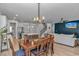 Open dining area featuring a wood table, statement lighting, and flow into the kitchen and living spaces at 456 Cattle Drive Circle, Myrtle Beach, SC 29588
