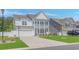 Charming two-story home with a white exterior, landscaped front yard, and a two-car garage at 456 Cattle Drive Circle, Myrtle Beach, SC 29588