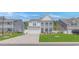 Charming two-story home with a white exterior, landscaped front yard, and a two-car garage at 456 Cattle Drive Circle, Myrtle Beach, SC 29588