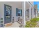 Cozy front porch featuring wicker seating, decorative lanterns, and a welcoming wreath on the front door at 456 Cattle Drive Circle, Myrtle Beach, SC 29588