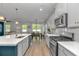 Bright and modern kitchen with stainless steel appliances and a view into the adjacent living area and dining space at 456 Cattle Drive Circle, Myrtle Beach, SC 29588