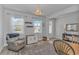 Inviting living room featuring a cozy armchair, natural light, and neutral decor at 456 Cattle Drive Circle, Myrtle Beach, SC 29588