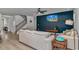Cozy living room boasts a modern color palette and media accent wall near the staircase at 456 Cattle Drive Circle, Myrtle Beach, SC 29588