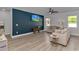 Bright living room with large windows, ceiling fan, stylish furnishings and decorative wall accents at 456 Cattle Drive Circle, Myrtle Beach, SC 29588