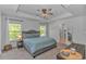 This spacious main bedroom has a tray ceiling, ceiling fan, and two windows overlooking the backyard at 456 Cattle Drive Circle, Myrtle Beach, SC 29588