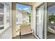 Balcony with neutral colored outdoor furniture and views of the building and outdoor foliage at 488 River Oaks Dr. # 61F, Myrtle Beach, SC 29579