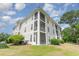 Condominium building showcasing private screened porches and well maintained landscaping at 488 River Oaks Dr. # 61F, Myrtle Beach, SC 29579