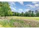 View of lush golf course featuring a sand trap and green fairways surrounded by trees at 488 River Oaks Dr. # 61F, Myrtle Beach, SC 29579