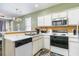 Functional kitchen with white cabinetry, a breakfast bar, and standard appliances at 488 River Oaks Dr. # 61F, Myrtle Beach, SC 29579