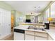 Clean kitchen with white countertops, stainless steel sink, and open access to the living area at 488 River Oaks Dr. # 61F, Myrtle Beach, SC 29579
