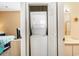 Convenient in-unit laundry featuring a stacked washer and dryer in an alcove near the bathroom at 488 River Oaks Dr. # 61F, Myrtle Beach, SC 29579