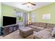 Comfortable living room with a plush sectional sofa, TV, and a sliding door to a balcony at 488 River Oaks Dr. # 61F, Myrtle Beach, SC 29579