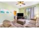 Cozy living room with a view into the bedroom and a sliding door to an outdoor balcony at 488 River Oaks Dr. # 61F, Myrtle Beach, SC 29579
