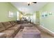 Open-concept living room showcasing the sofa, ottoman, and transition into the kitchen area at 488 River Oaks Dr. # 61F, Myrtle Beach, SC 29579