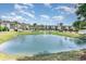Community pond with fountain, manicured lawn, and several residential buildings at 488 River Oaks Dr. # 61F, Myrtle Beach, SC 29579