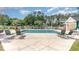 Community outdoor swimming pool surrounded by lounge chairs and green foliage at 488 River Oaks Dr. # 61F, Myrtle Beach, SC 29579