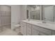 Elegant bathroom with dual sinks, a glass-enclosed shower, and a spacious walk-in closet at 527 Magnolia Terrace Dr, Myrtle Beach, SC 29579