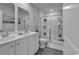 Bathroom featuring a double sink vanity and a glass-enclosed shower with tiled walls, creating a spa-like experience at 528 Courtridge Loop, Conway, SC 29526