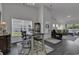Cozy dining area showcasing natural light, stylish furnishings, and seamless connectivity to the living room at 528 Courtridge Loop, Conway, SC 29526