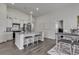 Charming white kitchen features stainless steel appliances, granite counters, backsplash, and a breakfast bar with seating at 528 Courtridge Loop, Conway, SC 29526