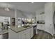 Spacious kitchen with a large island, stainless steel appliances, and seamless flow to the living area at 528 Courtridge Loop, Conway, SC 29526