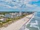 Beautiful aerial view of the beachfront condos along the shore with a vast beach on a sunny day at 5300 N Ocean Blvd. # 422, Myrtle Beach, SC 29572